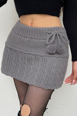 Jupe de Noël en tricot torsadé à pompons