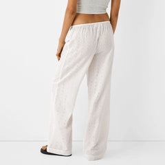 Pantalon palazzo décontracté à œillets et broderies florales mignonnes, jambes larges et taille haute.