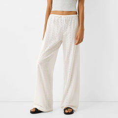 Pantalon palazzo décontracté à œillets et broderies florales mignonnes, jambes larges et taille haute.